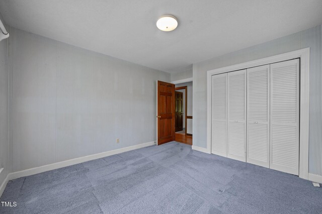 2610 N Main St, Tarboro, NC 27886 - unfurnished bedroom featuring carpet flooring, a closet, and baseboards