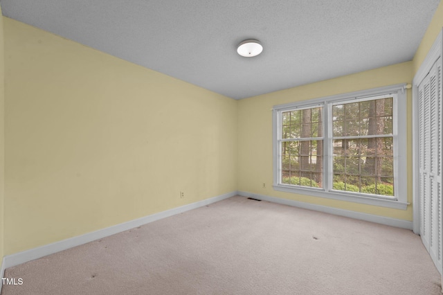 2610 N Main St, Tarboro, NC 27886 - unfurnished room with light colored carpet, baseboards, and a textured ceiling