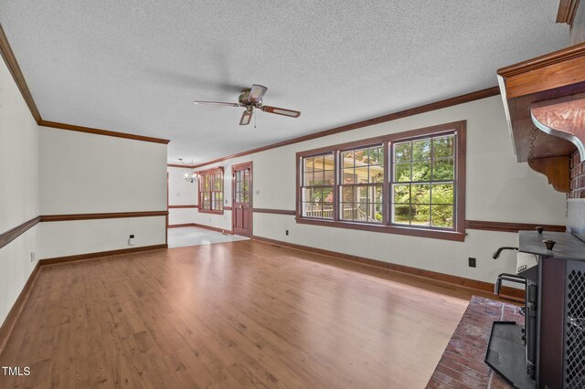 2610 N Main St, Tarboro, NC 27886 - unfurnished living room with ornamental molding, wood finished floors, ceiling fan, wainscoting, and plenty of natural light