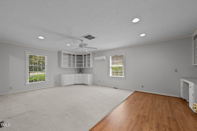 2610 N Main St, Tarboro, NC 27886 - unfurnished living room with an AC wall unit, a textured ceiling, recessed lighting, baseboards, and crown molding