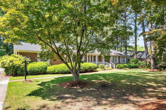 2610 N Main St, Tarboro, NC 27886 - view of front of property with a front yard, brick siding, and a porch