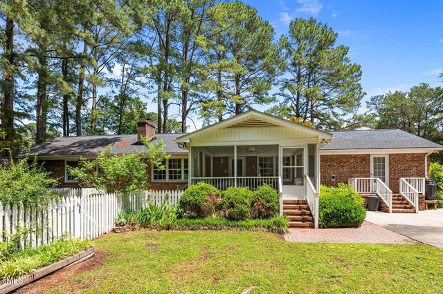 2610 N Main St, Tarboro, NC 27886 - view of front of home with brick siding, a sunroom, a chimney, and roof with shingles