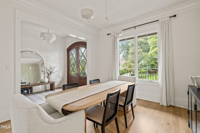 5308 Montclair Dr, Raleigh, NC 27609 - dining room with healthy amount of natural light, light wood-style floors, baseboards, and ornamental molding