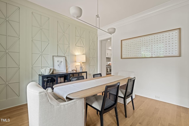5308 Montclair Dr, Raleigh, NC 27609 - dining area with wood finished floors, baseboards, and crown molding