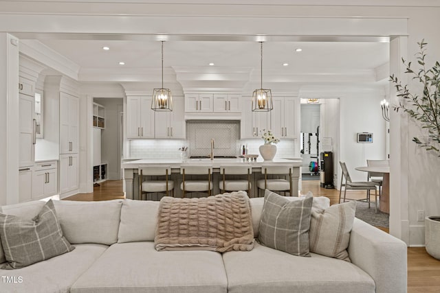 5308 Montclair Dr, Raleigh, NC 27609 - living area with light wood finished floors, ornamental molding, recessed lighting, and baseboards