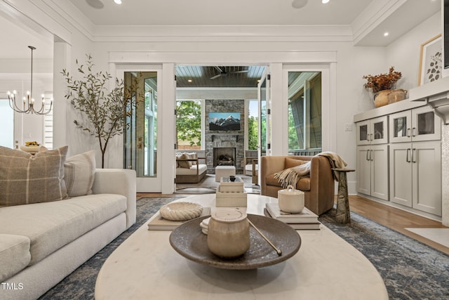 5308 Montclair Dr, Raleigh, NC 27609 - sitting room featuring crown molding, a chandelier, wood finished floors, a large fireplace, and recessed lighting
