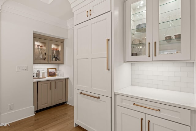 5308 Montclair Dr, Raleigh, NC 27609 - bar with backsplash, wood finished floors, and baseboards