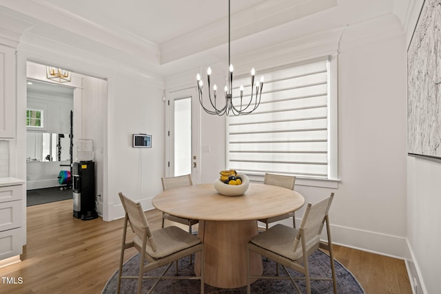 5308 Montclair Dr, Raleigh, NC 27609 - dining room featuring a chandelier, light wood-type flooring, ornamental molding, and baseboards