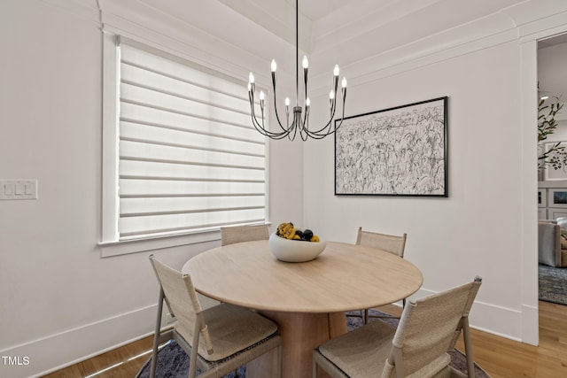 5308 Montclair Dr, Raleigh, NC 27609 - dining space featuring wood finished floors, baseboards, and a chandelier