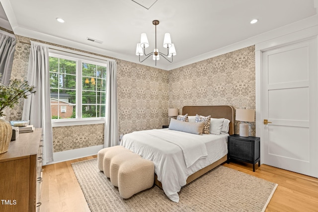 5308 Montclair Dr, Raleigh, NC 27609 - bedroom with wallpapered walls, a chandelier, light wood-type flooring, and ornamental molding