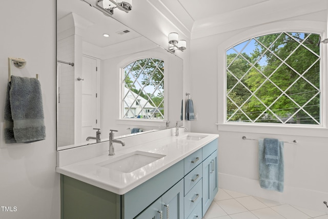 5308 Montclair Dr, Raleigh, NC 27609 - full bath with healthy amount of natural light, double vanity, and tile patterned floors