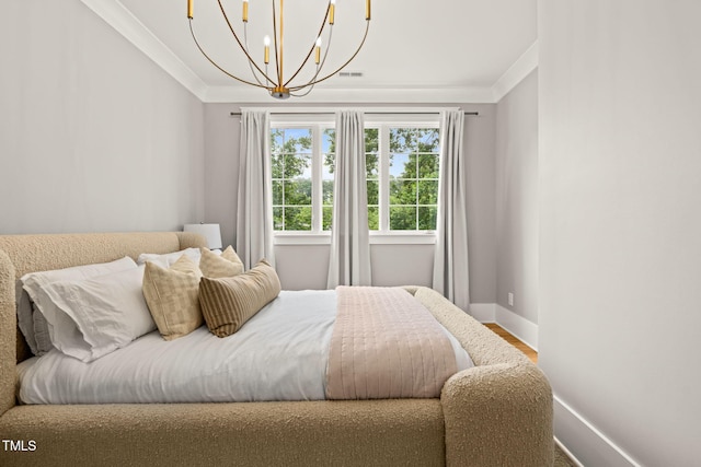 5308 Montclair Dr, Raleigh, NC 27609 - bedroom with baseboards, crown molding, a chandelier, and wood finished floors
