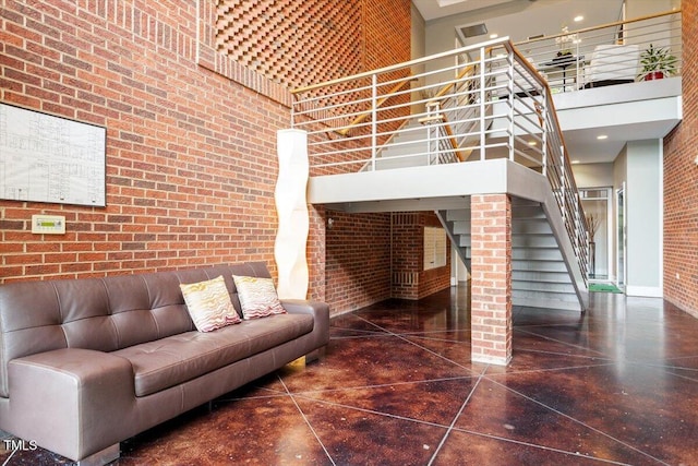 300 Finsbury St Unit 109, Durham, NC 27703 - living area featuring a high ceiling, brick wall, and stairs