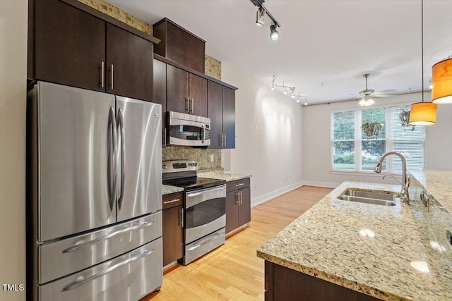 300 Finsbury St Unit 109, Durham, NC 27703 - kitchen featuring stainless steel appliances, a sink, a ceiling fan, light wood finished floors, and dark brown cabinets