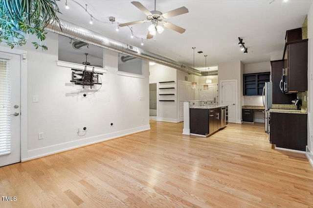 300 Finsbury St Unit 109, Durham, NC 27703 - kitchen with appliances with stainless steel finishes, track lighting, dark brown cabinetry, a kitchen island with sink, and a ceiling fan