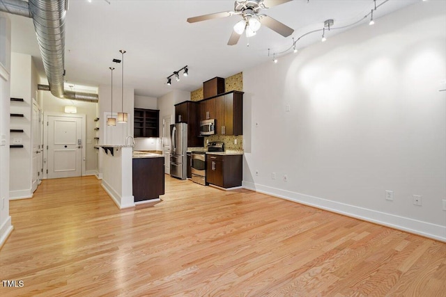 300 Finsbury St Unit 109, Durham, NC 27703 - kitchen featuring appliances with stainless steel finishes, track lighting, dark brown cabinets, ceiling fan, and tasteful backsplash