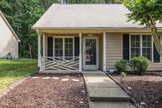 17 Crystal Oaks Ct, Durham, NC 27707 - doorway to property with covered porch and a lawn