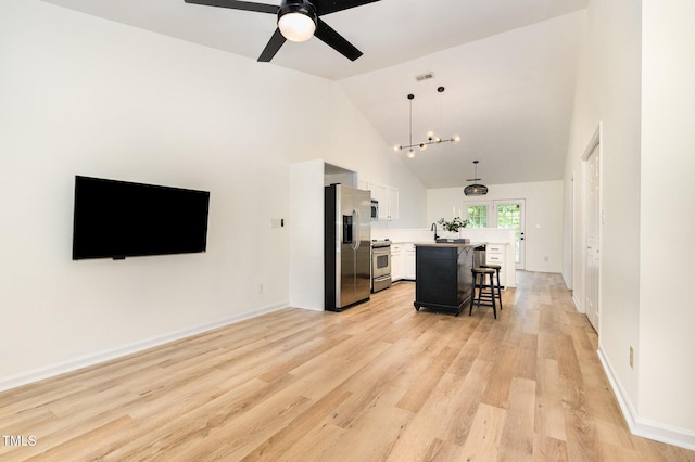 17 Crystal Oaks Ct, Durham, NC 27707 - kitchen featuring appliances with stainless steel finishes, a breakfast bar, light countertops, ceiling fan, and a kitchen island