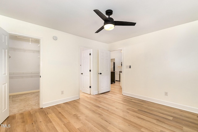 17 Crystal Oaks Ct, Durham, NC 27707 - unfurnished bedroom featuring attic access, light wood-style flooring, baseboards, and a walk in closet