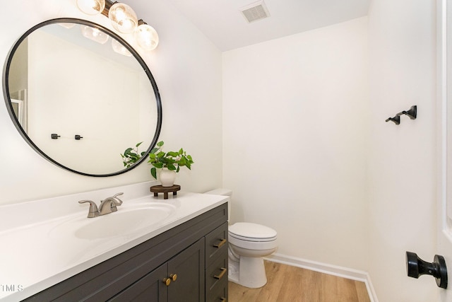 17 Crystal Oaks Ct, Durham, NC 27707 - bathroom with wood finished floors, toilet, vanity, and baseboards
