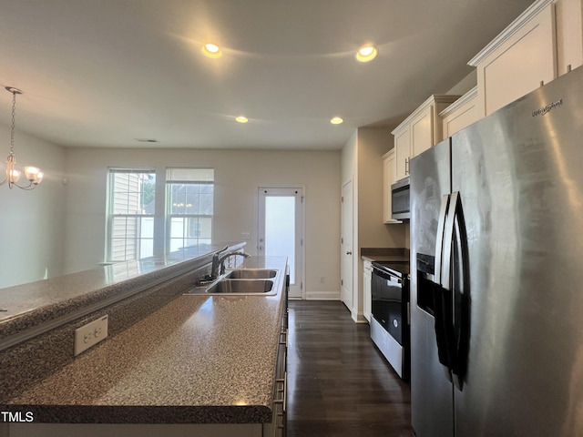 kitchen with appliances with stainless steel finishes, a sink, white cabinets, dark wood-type flooring, and recessed lighting