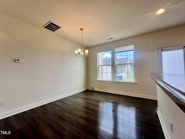 unfurnished dining area with a chandelier, baseboards, dark wood-type flooring, and recessed lighting