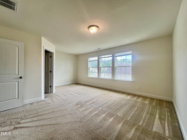 carpeted spare room with baseboards