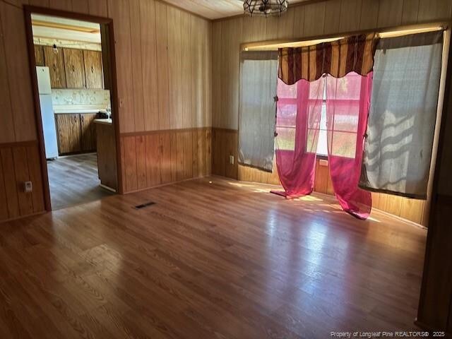 5689 NE Maxwell Rd NW, Stedman, NC 28391 - spare room featuring wood walls and wood finished floors