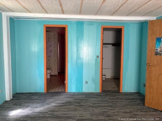 5689 NE Maxwell Rd NW, Stedman, NC 28391 - unfurnished bedroom with a spacious closet, a closet, wood finished floors, and ensuite bathroom