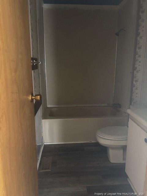 5689 NE Maxwell Rd NW, Stedman, NC 28391 - bathroom with vanity, tub / shower combination, and wood finished floors
