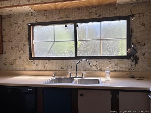 5689 NE Maxwell Rd NW, Stedman, NC 28391 - kitchen featuring dishwasher, light countertops, and wallpapered walls
