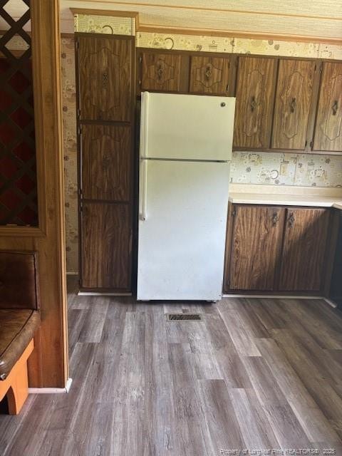 5689 NE Maxwell Rd NW, Stedman, NC 28391 - kitchen featuring freestanding refrigerator, light countertops, and dark wood-style flooring