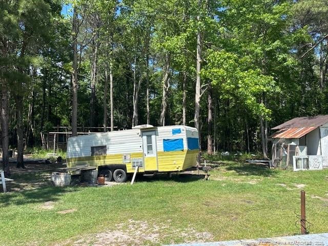 5689 NE Maxwell Rd NW, Stedman, NC 28391 - view of green lawn featuring an outbuilding and exterior structure