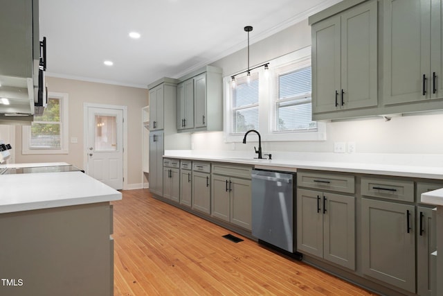 kitchen featuring dishwasher, a sink, ornamental molding, gray cabinetry, and light wood-style floors