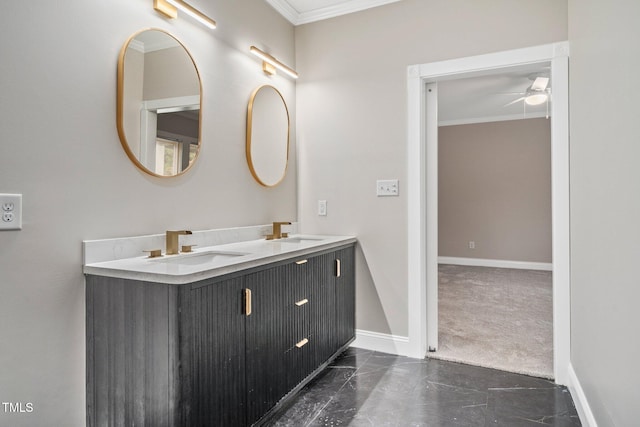 bathroom featuring crown molding, baseboards, marble finish floors, ceiling fan, and double vanity