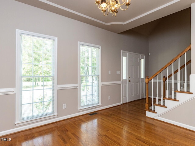 301 Monterey Ct, Benson, NC 27504 - entryway featuring a chandelier, wood finished floors, stairs, and healthy amount of natural light