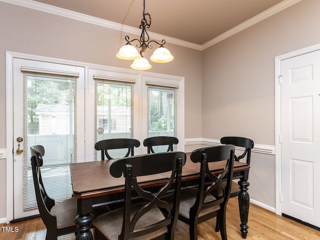 301 Monterey Ct, Benson, NC 27504 - dining space featuring plenty of natural light, light wood-type flooring, a chandelier, ornamental molding, and baseboards