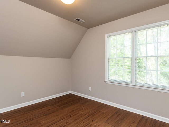 301 Monterey Ct, Benson, NC 27504 - additional living space featuring lofted ceiling, healthy amount of natural light, baseboards, and dark wood finished floors