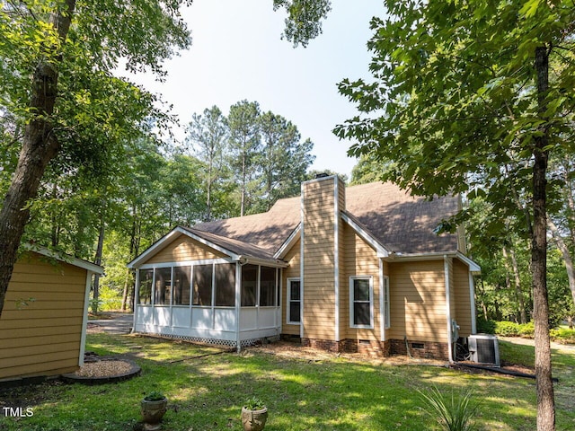 301 Monterey Ct, Benson, NC 27504 - back of property featuring a sunroom, crawl space, central air condition unit, a yard, and a chimney