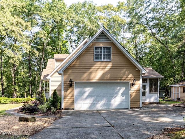 301 Monterey Ct, Benson, NC 27504 - view of front of house featuring concrete driveway, a garage, and a storage unit
