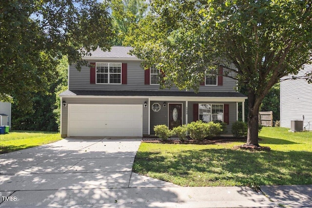 traditional-style house with a garage, concrete driveway, a front yard, and cooling unit
