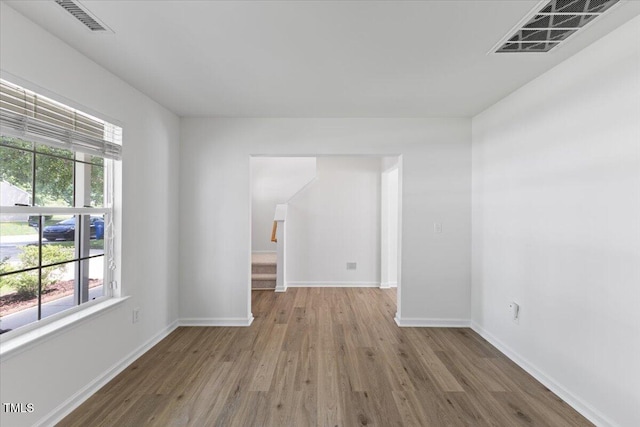 unfurnished room featuring wood finished floors and baseboards