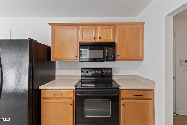 kitchen featuring black appliances and light countertops