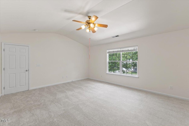 unfurnished room with ceiling fan, lofted ceiling, light colored carpet, and baseboards