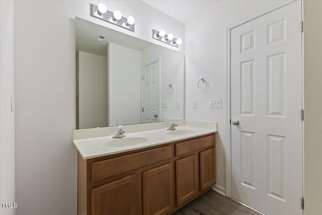bathroom featuring double vanity and wood finished floors