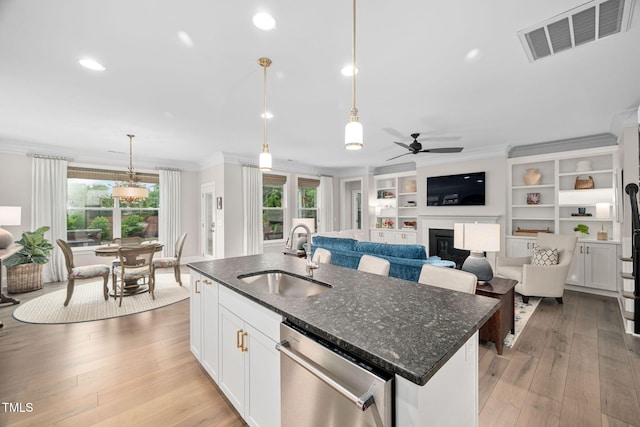 829 Churton Pl, Cary, NC 27518 - kitchen with a sink, dishwasher, crown molding, plenty of natural light, and a fireplace