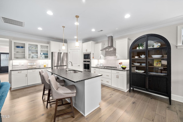 829 Churton Pl, Cary, NC 27518 - kitchen with stainless steel appliances, wall chimney exhaust hood, a sink, dark countertops, and white cabinets
