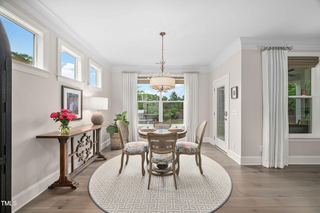 829 Churton Pl, Cary, NC 27518 - dining room featuring healthy amount of natural light, crown molding, a chandelier, baseboards, and hardwood / wood-style floors