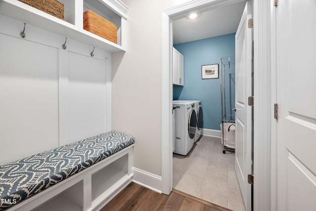 829 Churton Pl, Cary, NC 27518 - laundry area featuring washing machine and dryer, baseboards, cabinet space, and wood finished floors
