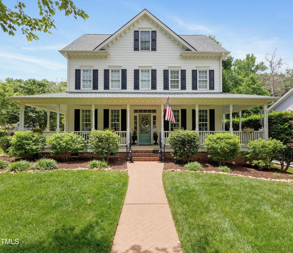 200 Cobblepoint Way, Holly Springs, NC 27540 - view of front facade with a porch, a front yard, and a shingled roof